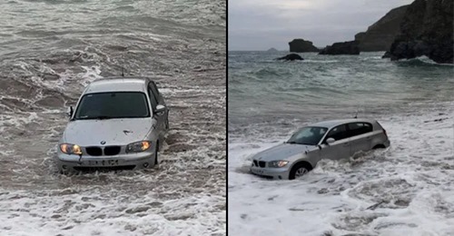 BMW vai parar ao mar depois de ter estacionado na praia